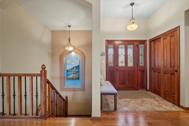 entryway with baseboards and wood finished floors