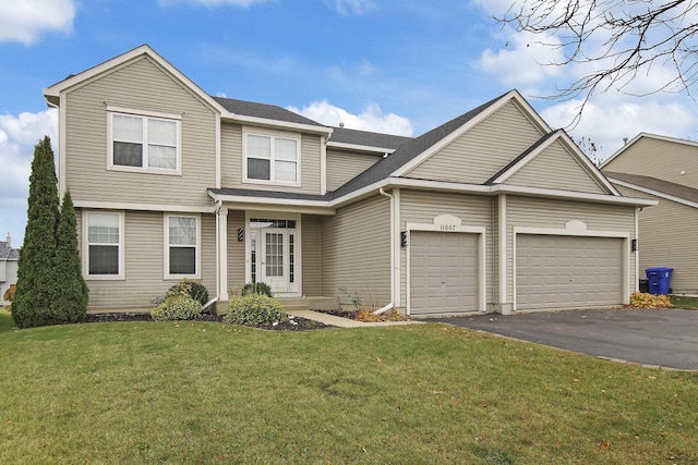 view of front of house featuring a garage, a front yard, driveway, and a shingled roof