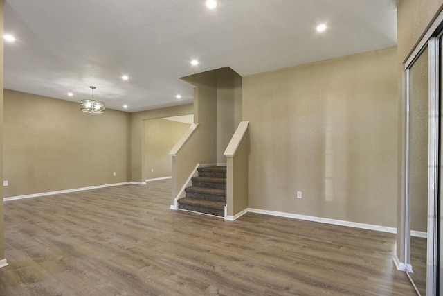 basement featuring stairway, recessed lighting, baseboards, and wood finished floors