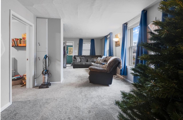 carpeted living room with baseboards