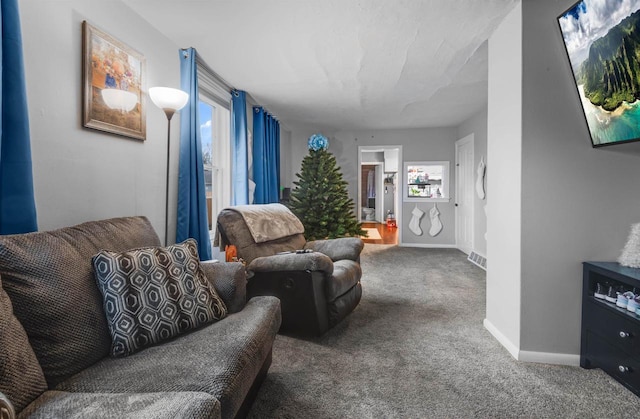 living room featuring visible vents, baseboards, and carpet flooring