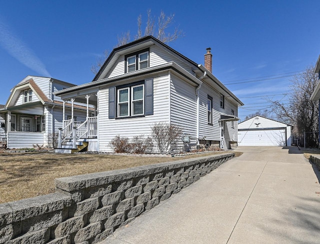 view of property exterior featuring an outbuilding, a porch, a chimney, and a garage