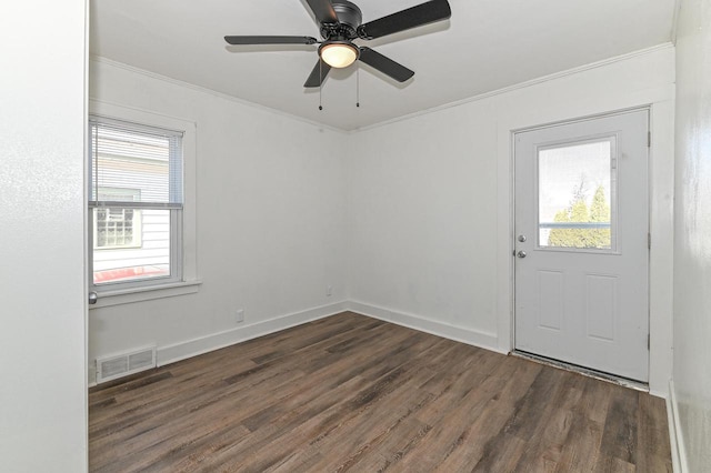 unfurnished room featuring visible vents, a ceiling fan, wood finished floors, crown molding, and baseboards