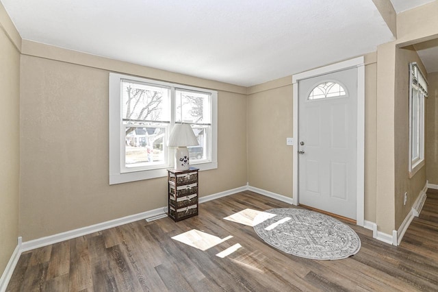 entryway featuring baseboards and wood finished floors