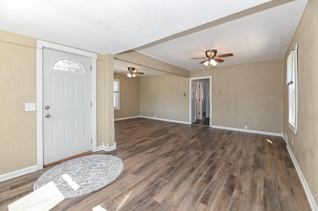 foyer with wood finished floors, a ceiling fan, and baseboards