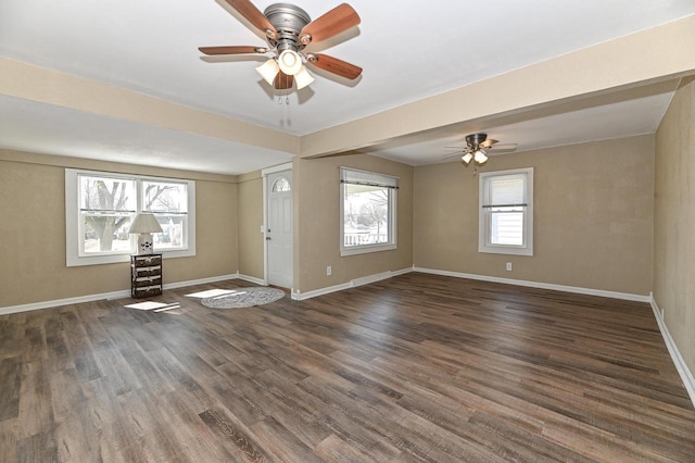 empty room with baseboards, a ceiling fan, and wood finished floors