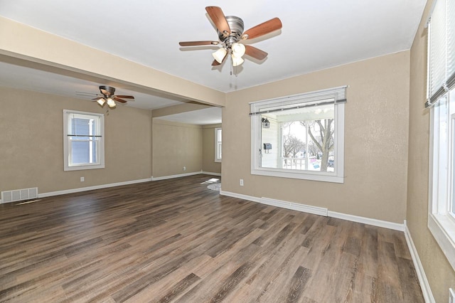 spare room with visible vents, baseboards, ceiling fan, and wood finished floors