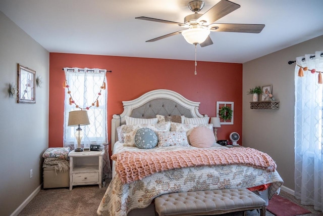 bedroom with a ceiling fan, baseboards, and carpet floors