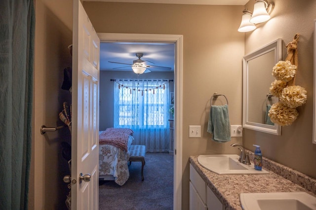 full bathroom with a sink, connected bathroom, ceiling fan, and double vanity