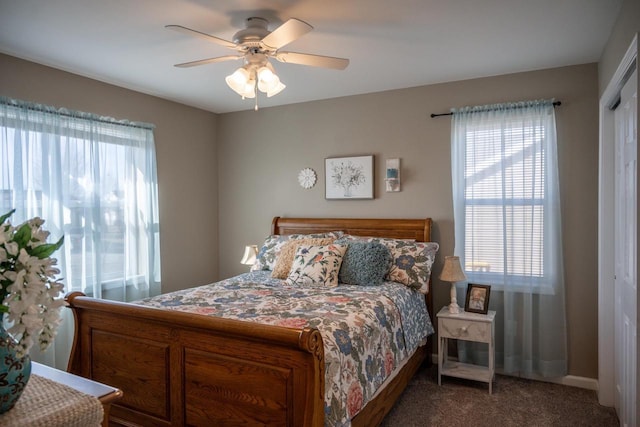 carpeted bedroom with multiple windows and ceiling fan