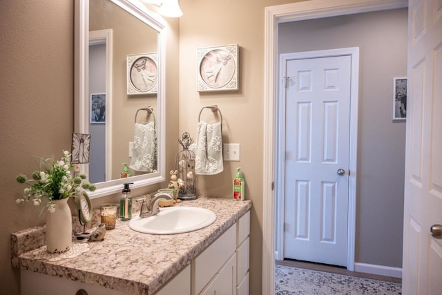 bathroom featuring vanity and baseboards