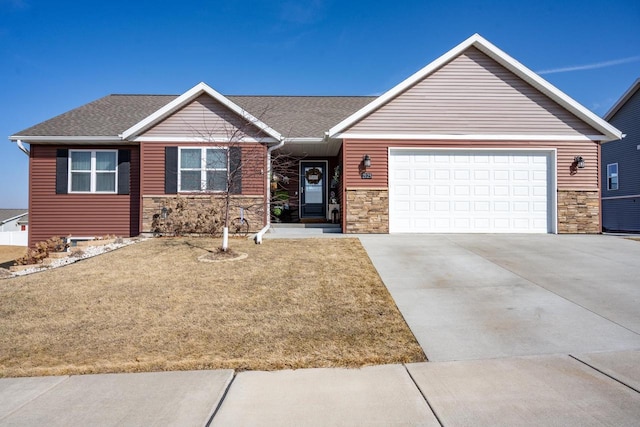 single story home featuring driveway, a garage, and stone siding