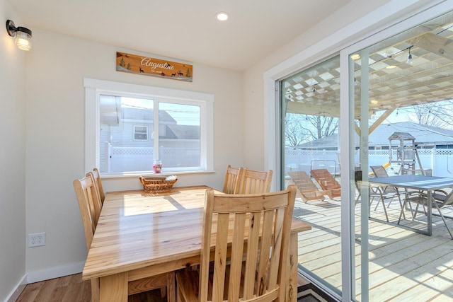 dining room with recessed lighting, baseboards, and wood finished floors