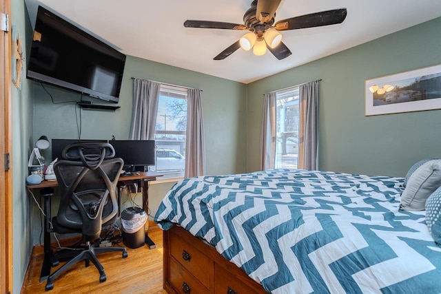 bedroom with multiple windows, light wood-type flooring, and ceiling fan