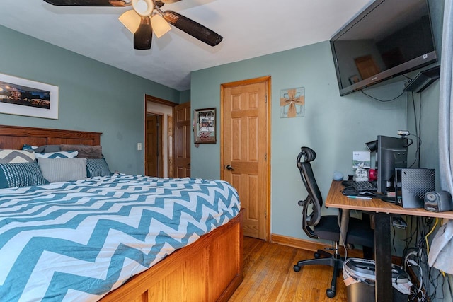 bedroom with baseboards, light wood finished floors, and ceiling fan