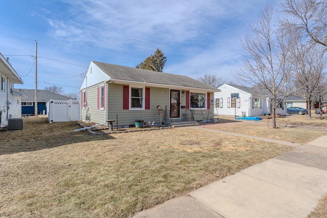 view of front of home with fence, a porch, a front yard, cooling unit, and a gate