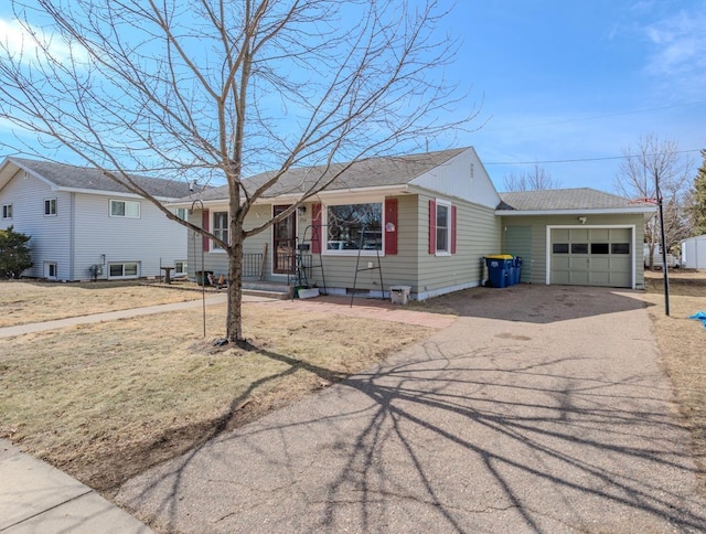 ranch-style home featuring aphalt driveway, an attached garage, and a shingled roof