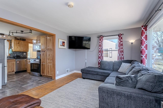 living area featuring visible vents, baseboards, and dark wood-type flooring