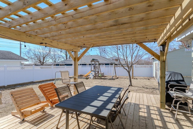 wooden terrace featuring a fenced backyard, outdoor dining space, and a pergola