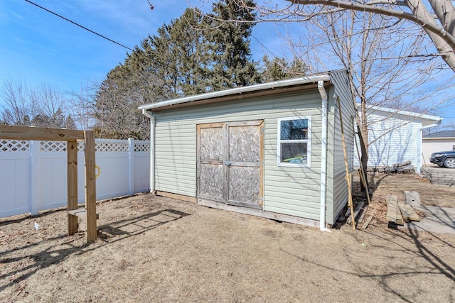 view of shed featuring fence