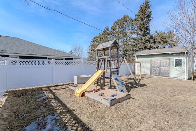 view of playground with an outdoor structure and a fenced backyard