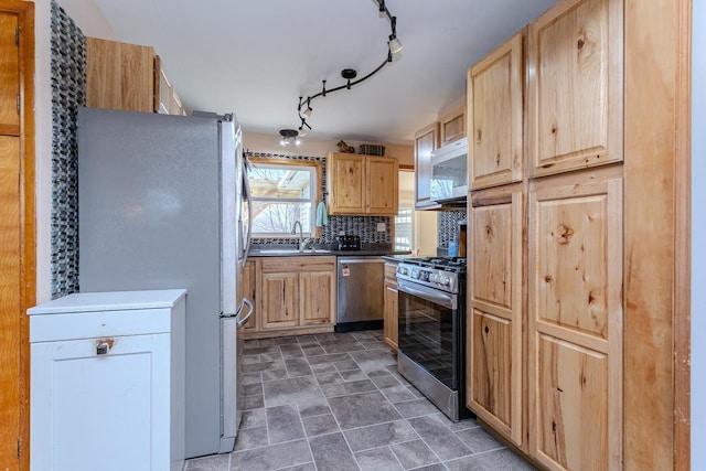 kitchen featuring dark countertops, light brown cabinets, backsplash, and stainless steel appliances