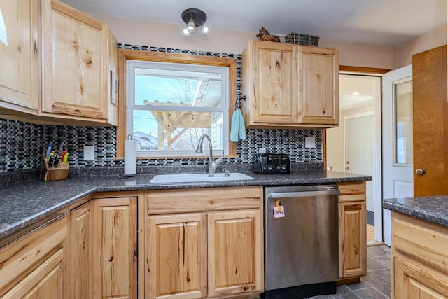 kitchen featuring light brown cabinets, a sink, backsplash, dark countertops, and dishwasher