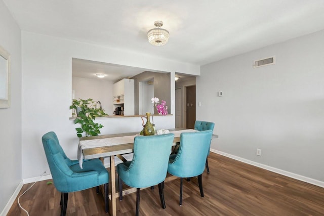 dining space featuring visible vents, baseboards, and dark wood-style flooring