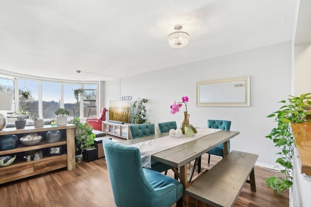 dining room featuring wood finished floors and floor to ceiling windows