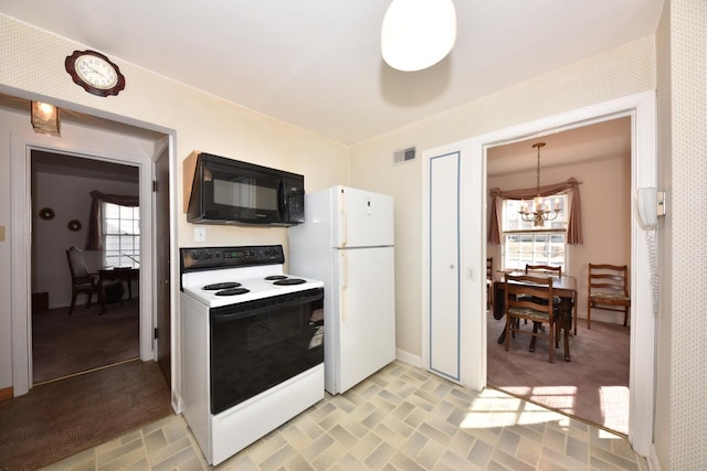 kitchen featuring visible vents, white appliances, baseboards, and an inviting chandelier