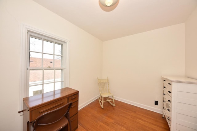 office area featuring baseboards and light wood-style flooring