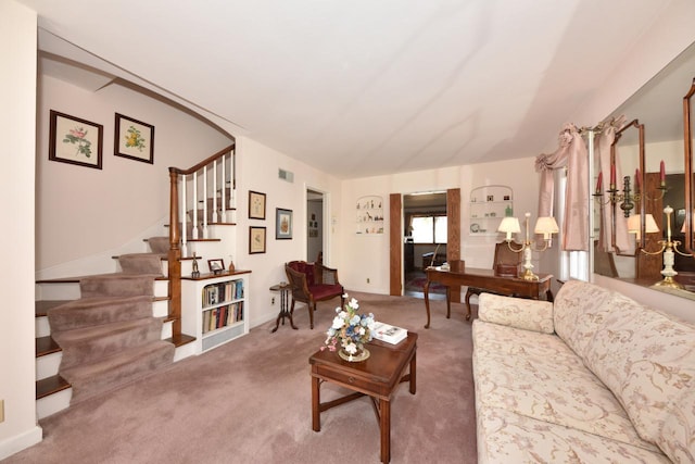 living area featuring stairway, carpet, and visible vents