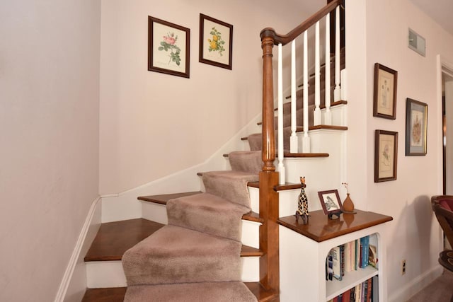 staircase featuring visible vents and baseboards