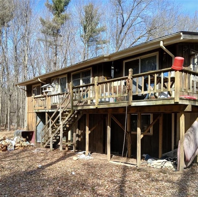 rear view of property with a deck and stairs