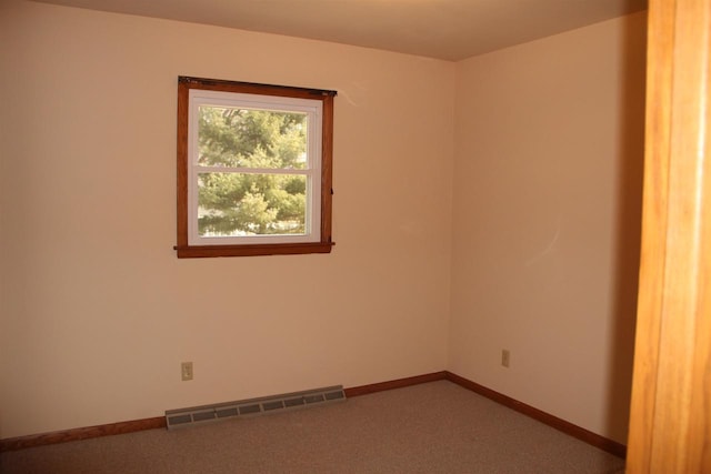 unfurnished room featuring carpet flooring, baseboards, and visible vents