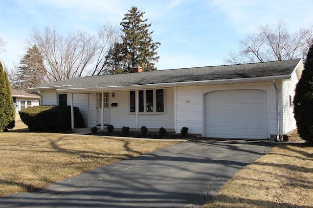 single story home featuring aphalt driveway, a chimney, and a garage