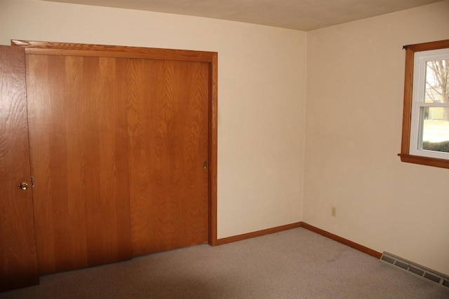 unfurnished bedroom featuring visible vents, baseboards, and carpet