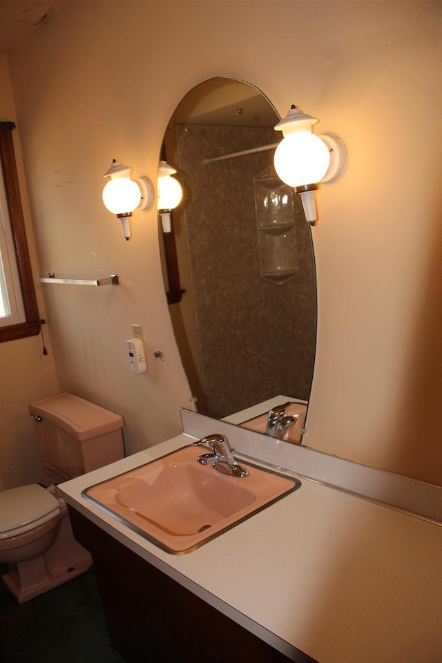 bathroom featuring toilet and vanity