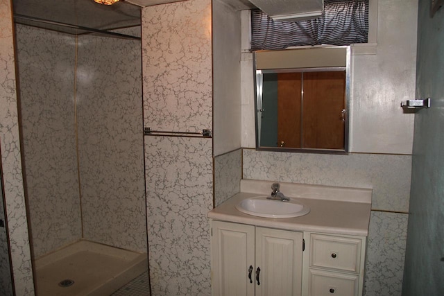 full bath with vanity and a shower stall