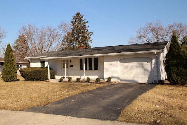 single story home featuring driveway, a chimney, and an attached garage