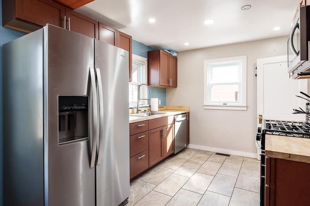 kitchen with plenty of natural light, stainless steel appliances, visible vents, and a sink