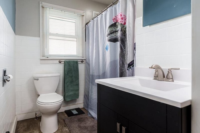 bathroom with vanity, tile walls, toilet, and wood finished floors