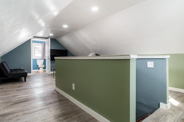 bonus room featuring recessed lighting, baseboards, lofted ceiling, and wood finished floors