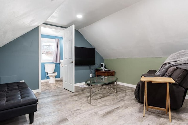 sitting room featuring baseboards, lofted ceiling, and wood finished floors