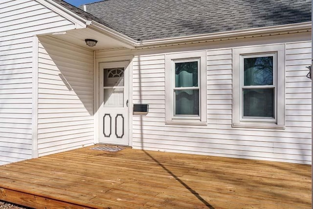 property entrance featuring roof with shingles