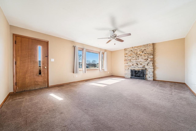 unfurnished living room with baseboards, carpet, ceiling fan, and a fireplace