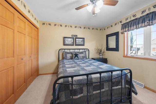 bedroom with carpet flooring, baseboards, visible vents, and a closet