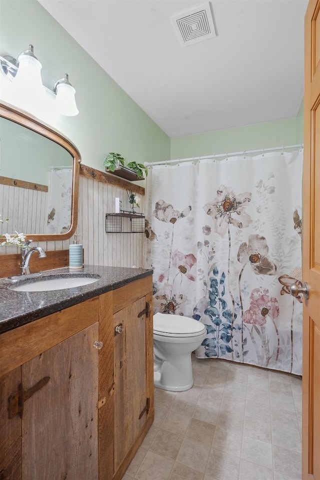 bathroom featuring visible vents, toilet, and vanity