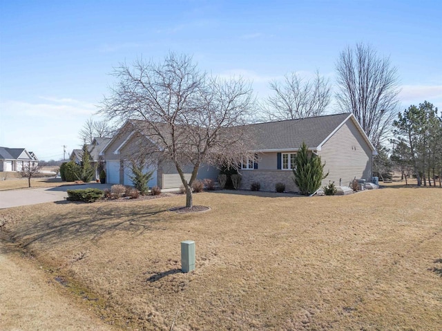 single story home with a front lawn, a garage, and driveway