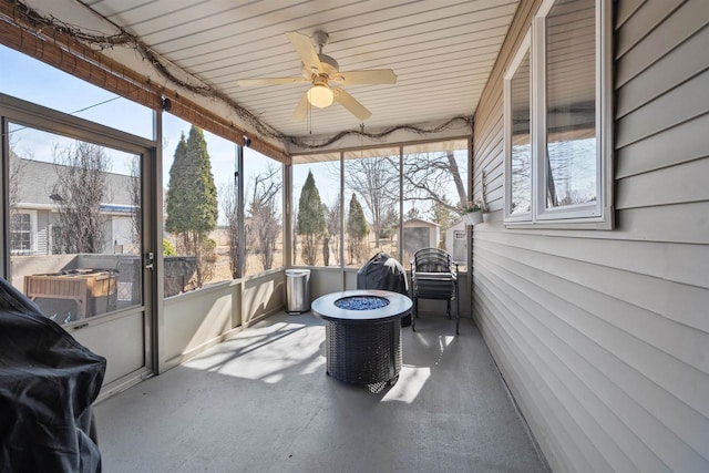 sunroom / solarium with a healthy amount of sunlight and a ceiling fan